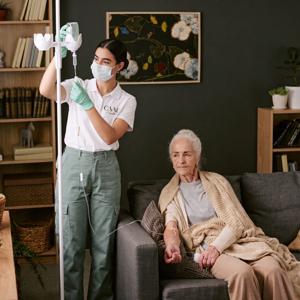 CAAE Health nurse setting up IV therapy for an older woman at home in Tucson
